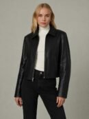 Woman wearing black faux leather jacket front view