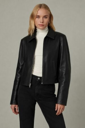 Woman wearing black faux leather jacket front view